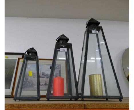 Three lantern style candle holders, tallest +/- 55 cm