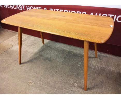 An Ercol elm and beech plank top Windsor dining table 