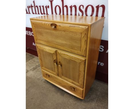 An Ercol blonde elm Windsor writing cabinet 