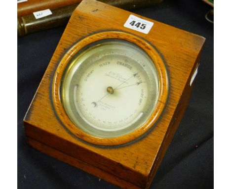 A late nineteenth century brass encased circular dial barometer by C W DIXEY in a glazed oak case Condition reports are provi