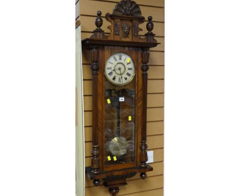 An antique walnut veneer Vienna-type wall clock of architectural form with Roman numeral dial, 120cms high Condition reports 