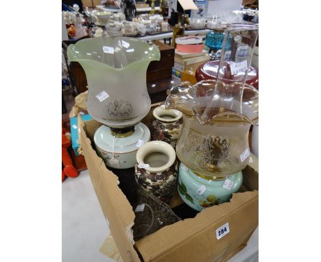 Two antique oil lamps with metal bases &amp; milk glass reservoirs, together with a spare oil lamp shade &amp; a pair of Sats