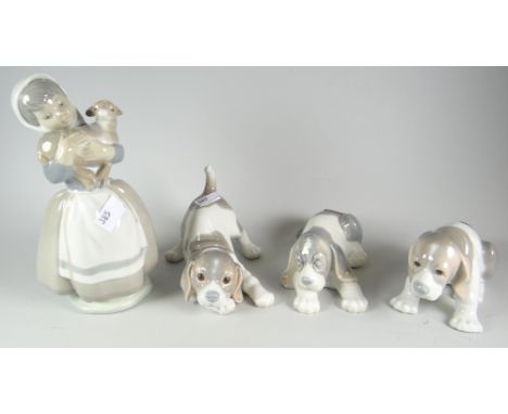 A Nao figure of a girl with lamb &amp; three Lladro puppies Condition reports are provided on request by email only for this 