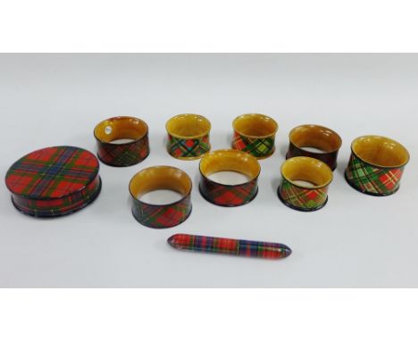 Group of late 19th century Mauchline 'Tartan Ware' to include eight napkin rings, snuff box, thread box, and a bodkin holder,