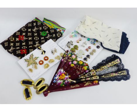 A mixed lot to include&nbsp;an Yves St Laurent scarf, clip on earrings, Trifari costume brooches and others together with clo