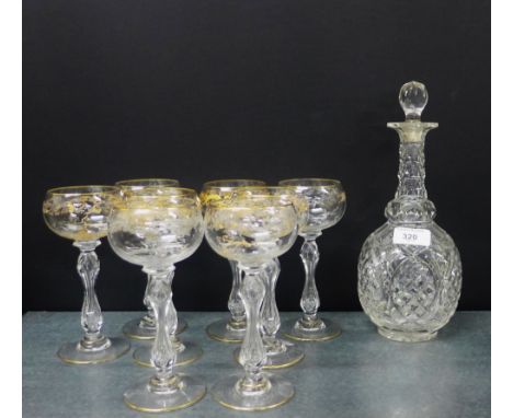 Cut crystal decanter and stopper, together with a set of eight wine glasses with gilt etched decoration, (9)