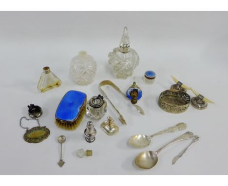 A mixed lot to include silver collared scent bottles, Sheffield silver knife rests, enamel backed clothes brush, silver teasp