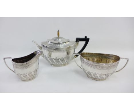 Victorian silver teaset by Edward Hutton, London 1886, comprising teapot, cream jug and twin handled sucrier (3) 