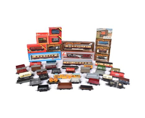 An assortment of vintage model railway trainset wagons, coaches and carriages from various makers such as; Hornby, Mainline, 