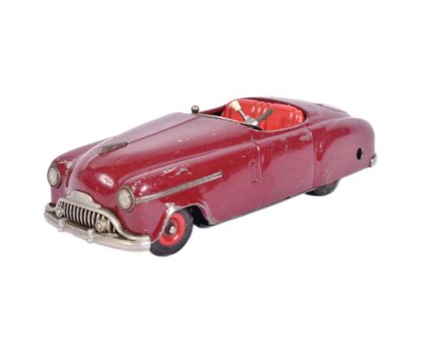 An original vintage West German Schuco made tinplate clockwork model car ' Combinato 4003 '. The clockwork mechanism with a f