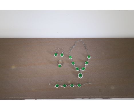 JadeChinaOpulent jade jewellery consisting of necklace, earrings and bracelet made in a European style.