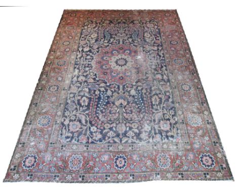 ANTIQUE PERSIAN TABRIZ CARPET, 353cm x 233cm, circa 1890, terracotta medallion on a midnight blue field of scrolling foliage 