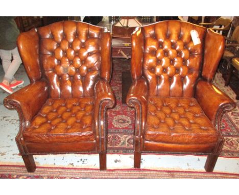 WINGBACK ARMCHAIRS, a pair, George III design tan brown leather each with deep button upholstered back and cushion seat. (2)