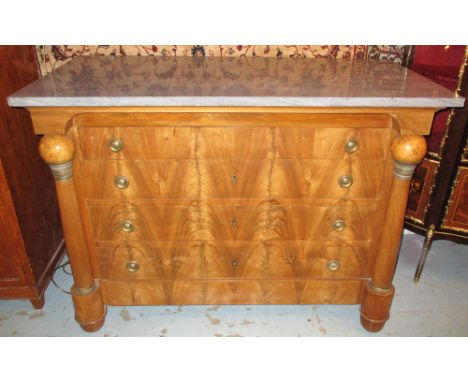 COMMODE, Charles X walnut and gilt metal mounted circa 1825 with a grey marble top over five long drawers flanked by ball hea