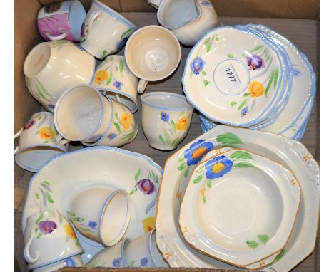 An early 20th century ten-setting tea service, boldly painted with tulips in tones of purple, yellow and blue on an ivory gro