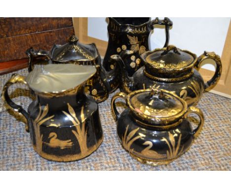 A late Victorian 'Jackfield' type three piece tea service, each printed in gilt with swan and bulrushes, c.1890;  a similar t