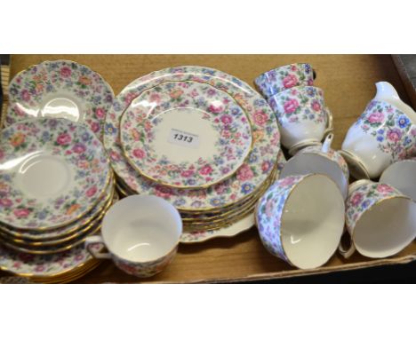  A Crown Staffordshire six-setting tea service, decorated with Chintz flowers, comprising milk jug, sugar bowl, tea cups and 