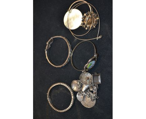 A Mexican silver charm bracelet, stamped 925; a silver hinged bangle, hallmarked; another, white metal; white metal and filig