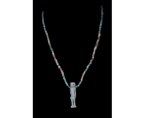 Late Period, Ca. 664-32 BC.A large, green, glazed faience composition amulet of Thoth represented as a naturalistic baboon, t