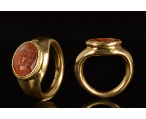 Ca. 200 AD.A gold ring with a circular hoop and a bezel set with carnelian stone intaglio depicting an emperor, possibly Cara