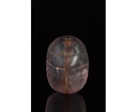 Ca. 1550-1070 BC.A naturalistically modelled amethyst scarab with a small head, and folded wings. Pierced lengthways for susp