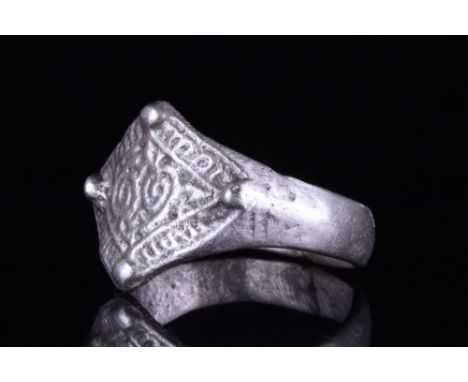 Viking Age, Ca. 900-1100 AD.A wearable silver ring with a round-section hoop and a lozenge-shaped bezel with two pairs of rai