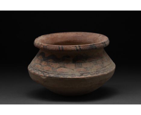 Ca. 3000-2000 BC.A thick-walled, wheel-thrown pottery vessel standing on a small foot, the bottom section of the body flares 