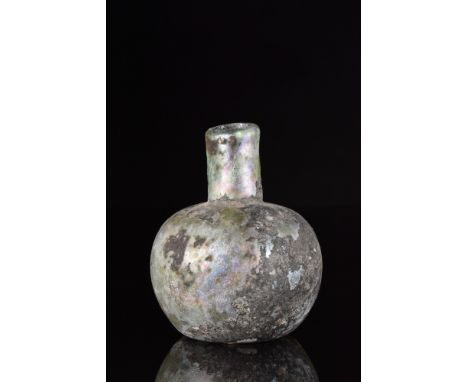 Ca. 100-300 AD.A beautiful glass flask with a tubular neck and a globular, apple-shaped body with slightly concave base. Glas