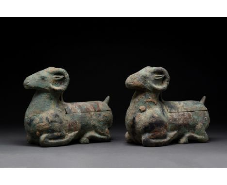 Han Dynasty, Ca. 206 BC.A hollow-cast oil lamp in the form of a recumbent ram with a head raised with long, ribbed horns curl