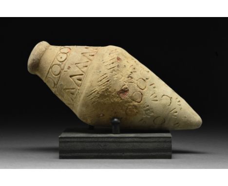 Ca. 900-1100 AD.A cream-coloured "Greek fire" hand grenade comprising a domed lid and a biconical body decorated with linear,