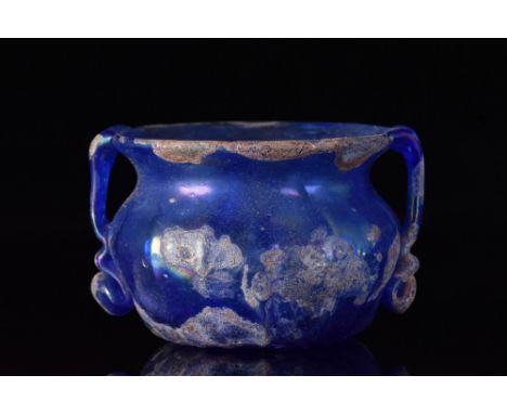 Ca. 100-300 AD.A stunning glass bowl in a cobalt blue with a slightly everted rim, a squat bowl, concave base, and moulded ve