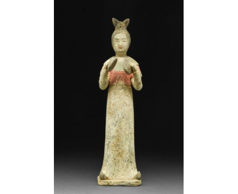 Ca. 618-907 AD. A mould-formed pottery tomb attendant figure in the form of a female musician who is wearing a long robe with