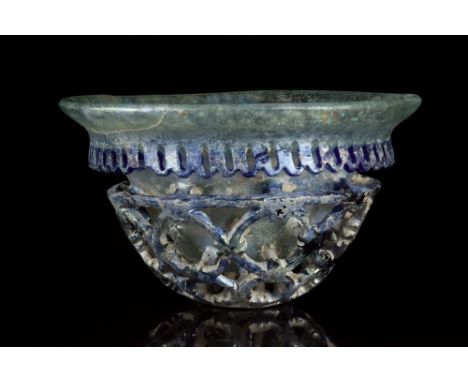 Ca. 250 - 400 AD.A glass cage-cup with a pale iridescent hemispherical body with rounded base, curved and outsplayed rim; whe