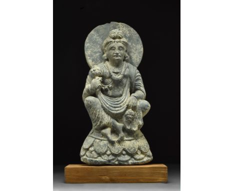 Ca. 400-500 AD.A grey chlorite-schist statue of the Bodhisattva Maitreya seated in the so-called "European pose” with his fee