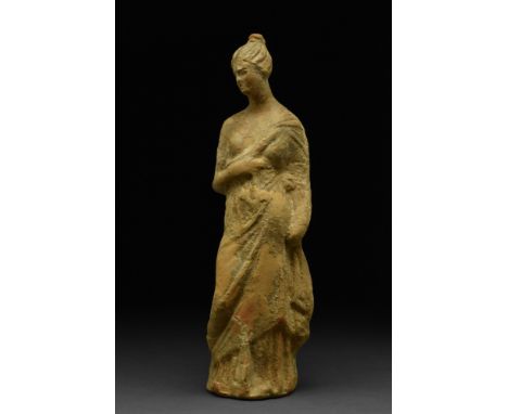 Ca. 300-200 BC.A well formed hollow-cast terracotta young female figure with delicately modelled face, an elaborate coiffure 