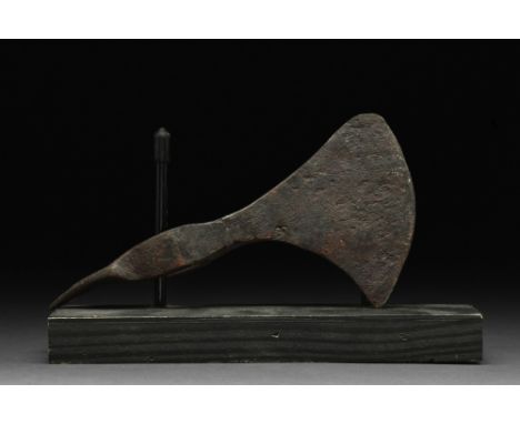 Ca. 900-1000 AD.An iron axe head with a curved blade, slim cheek, elliptical shaft-hole, and a spike at the rear. Axes were c