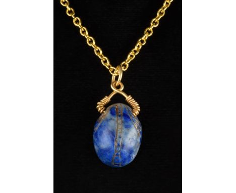Ca. 500 BC.A finely modelled lapis lazuli scarab with its oval body gently rounded, upper side detailing the clypeus, prothor