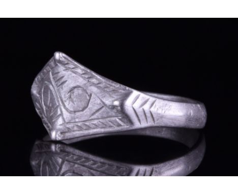 Viking Age, Ca. 900-1100 AD.A wearable silver ring with a round-section hoop and a lozenge-shaped bezel with two pairs of rai