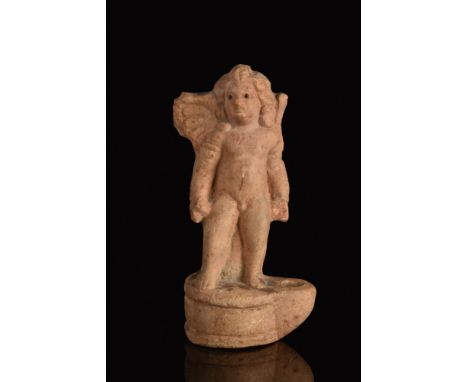 Ca. 100-300 AD.A lovely terracotta oil lamp with a columnar projection depicting standing cherub with his characteristic chub