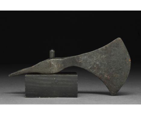 Ca. 900-1100 AD.An iron axe head with a curved blade, slim cheek, elliptical shaft-hole, and a spike at the rear. Axes were c