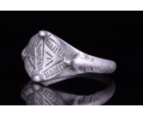 Viking Age, Ca. 900-1100 AD.A wearable silver ring with a round-section hoop and a lozenge-shaped bezel with two pairs of rai