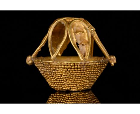 Byzantine Period, Ca. 1100-1300 AD.A gold pendant/bead shaped as a boat; the hull has a delicate granulated decoration and is
