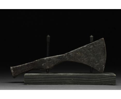 Ca. 900-1000 AD.An iron axe head comprising a short, curved blade, elongated cheek, and round socket. For more information on