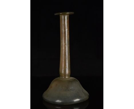 Ca. 100-300 AD.A beautiful glass candlestick unguentarium with a folded rim, long, cylindrical neck, and a bell-shaped body w