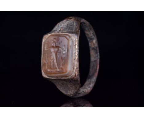 Ca. 200 AD.A fine silver ring with a circular band, flared shoulders, an octagonal gem set in a square bezel decorated with a