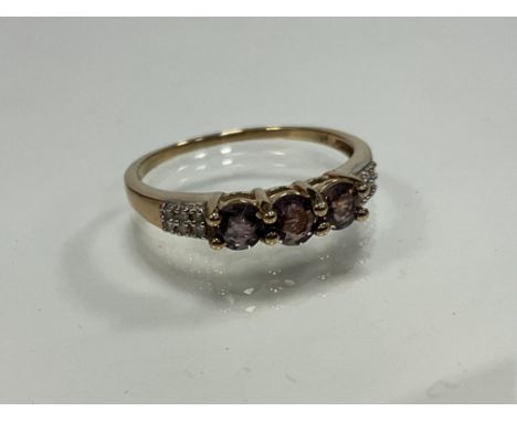 A 9ct yellow gold 3-stone polychroic tourmaline dress ring with diamond double row shoulders, size S, 1.9g gross