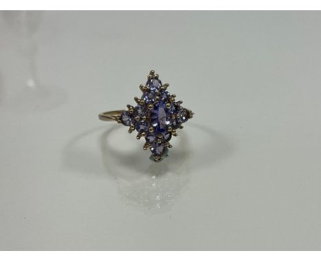 A 9ct yellow gold dress ring set with round and oval tanzanites and small diamonds. Tanzanites 1.00ct approx. Diamonds 0.02ct