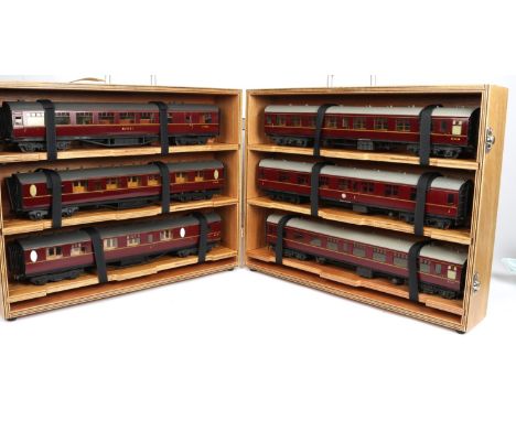 A rake of 6 finescale O Gauge BR bogie passenger coaches by Wayoh Models. All finished in lined maroon livery, with grey roof