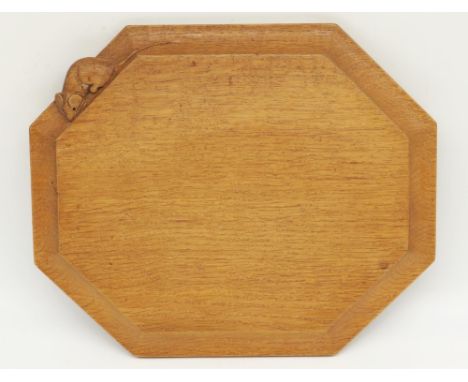 Robert Mouseman Thompson of Kilburn - an adzed oak canted rectangular breadboard, carved with signature mouse, W31cm D25cm 