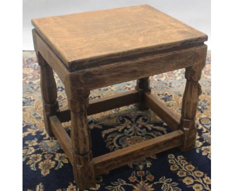 Robert Mouseman Thompson of Kilburn - an oak rectangular stool, adzed top on octagonal tapered and block supports with stretc